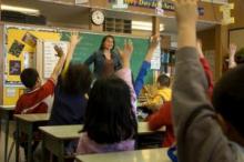 Photo of student and teacher in a classroom setting